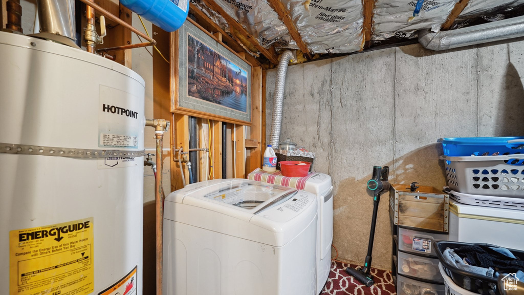 Interior space with gas water heater, washer and clothes dryer, and laundry area