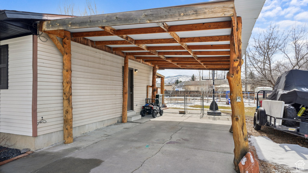 View of patio with a gate and fence