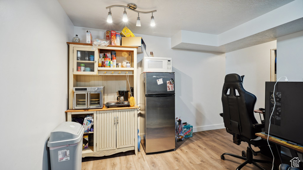 Office space with baseboards and wood finished floors