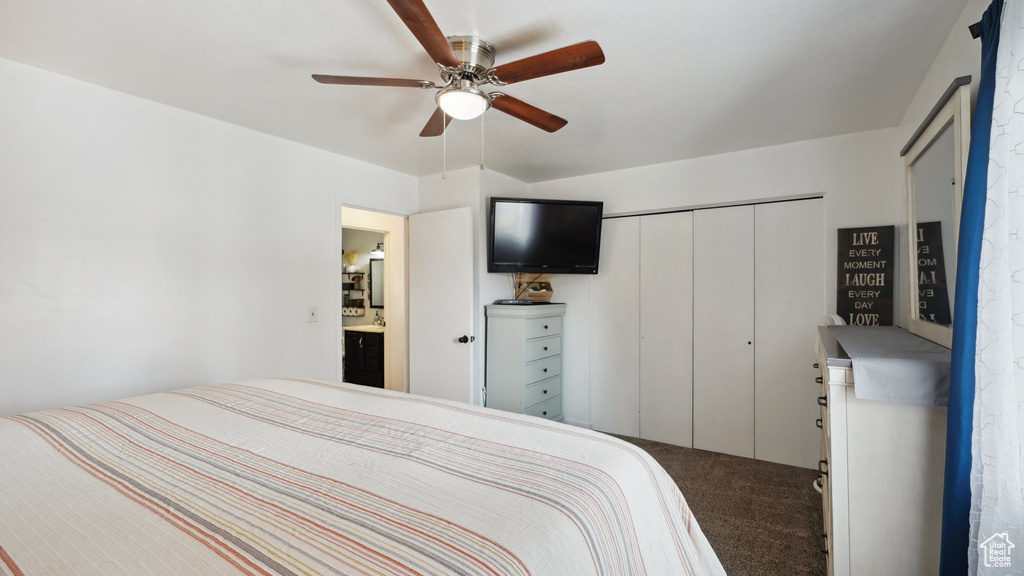 Carpeted bedroom featuring a closet and a ceiling fan
