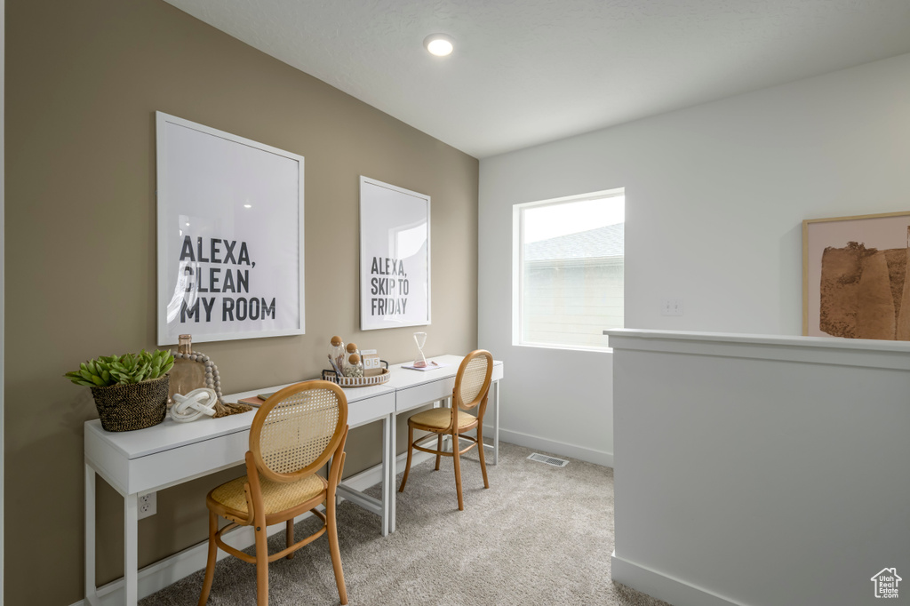 Office with visible vents, baseboards, and carpet