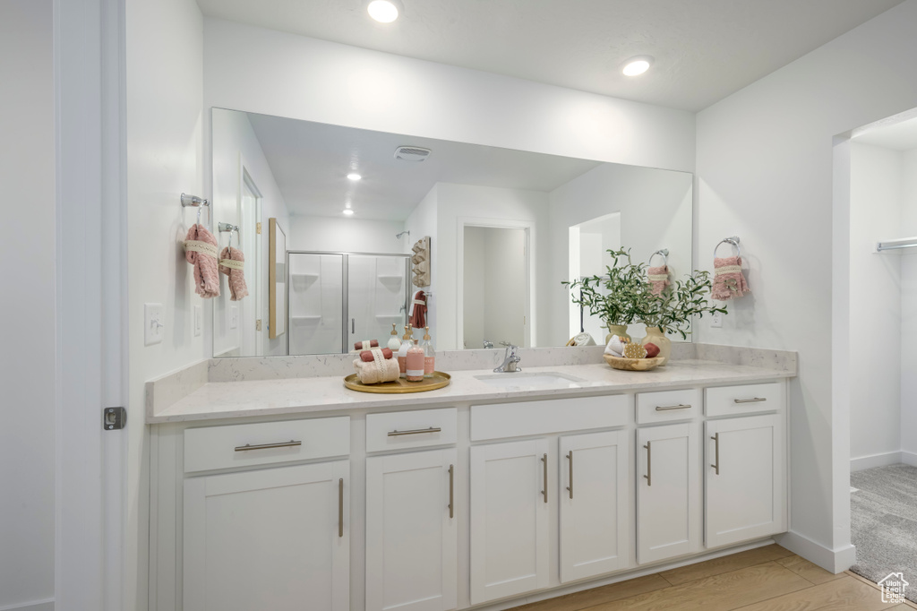 Bathroom featuring recessed lighting, a stall shower, vanity, and baseboards