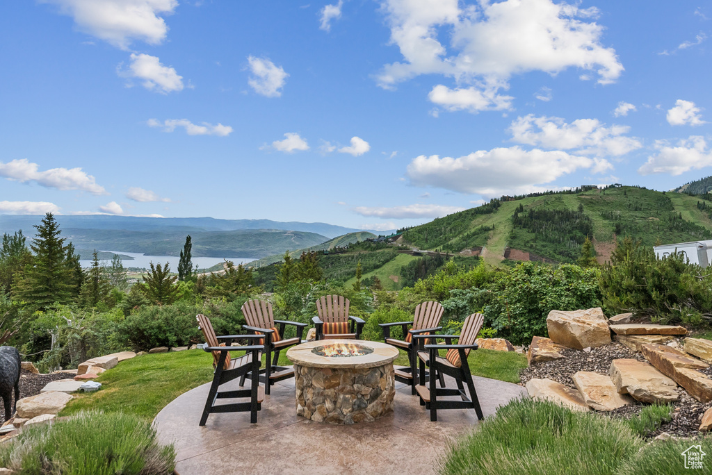 View of patio / terrace featuring an outdoor fire pit and a mountain view