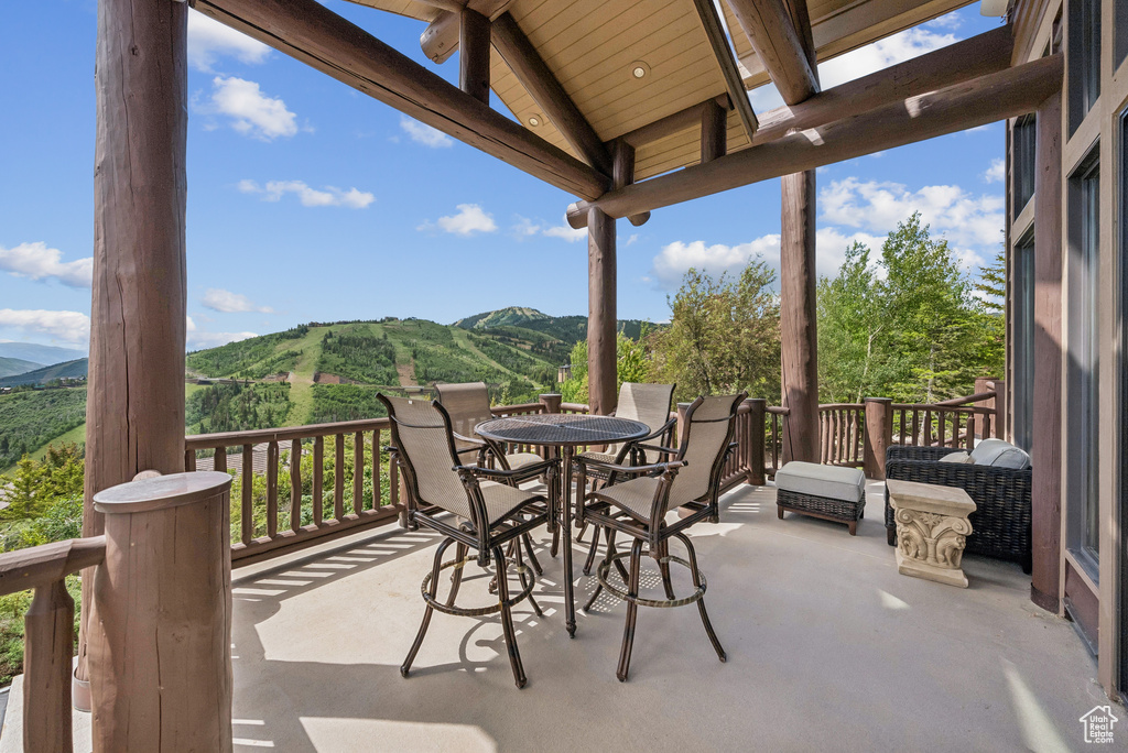 View of patio with a mountain view and outdoor dining area