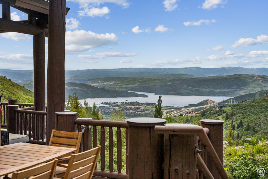 Balcony featuring a water and mountain view