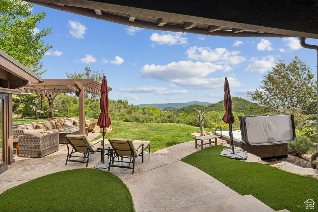 View of patio featuring an outdoor hangout area, a pergola, and a mountain view