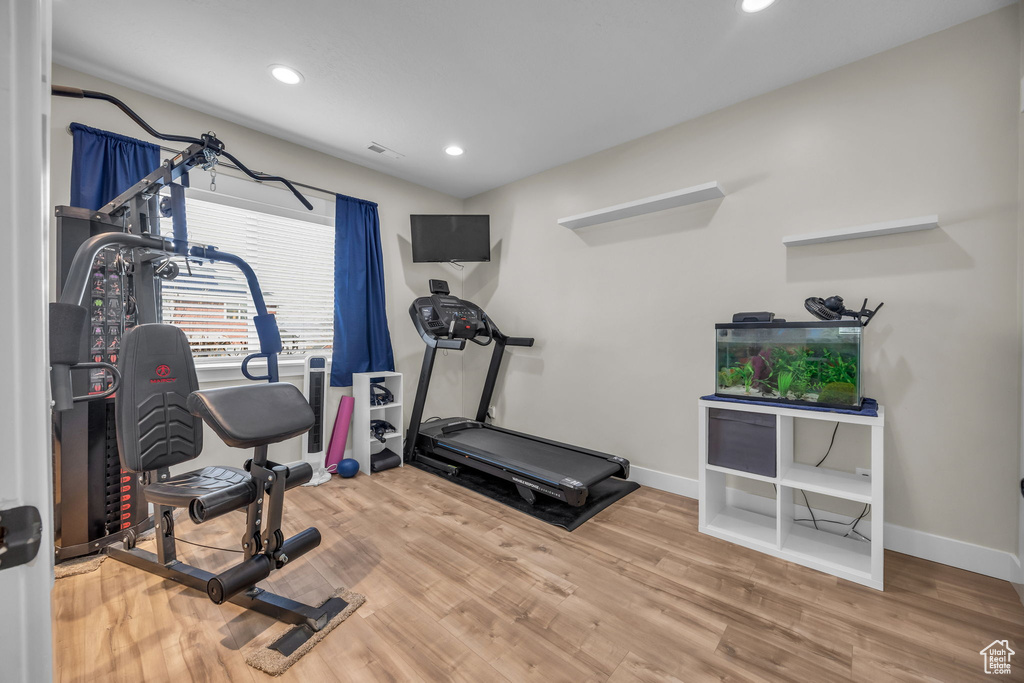 Workout area featuring recessed lighting, visible vents, baseboards, and wood finished floors