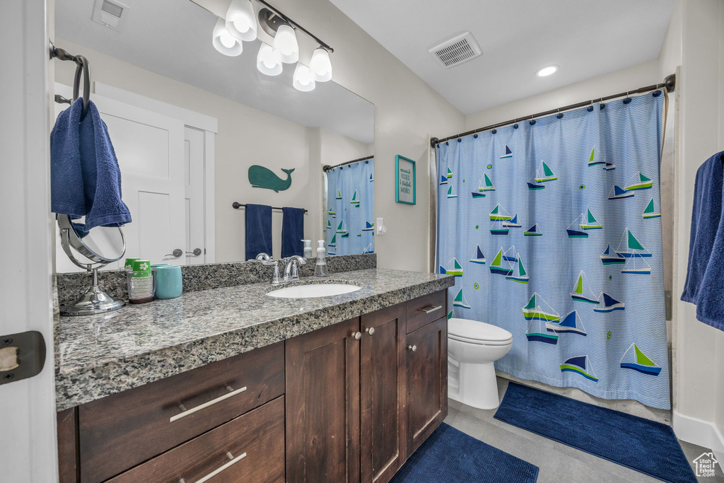 Full bath with a shower with shower curtain, visible vents, toilet, and vanity