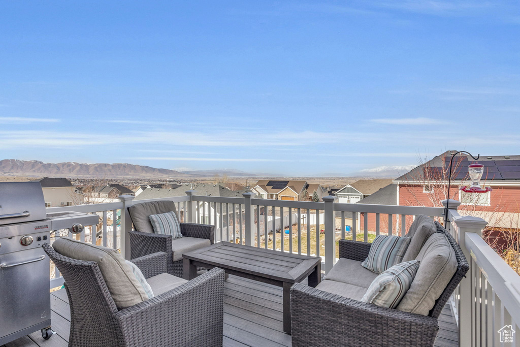 Wooden deck featuring a mountain view and a residential view