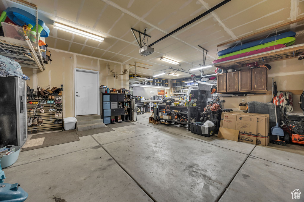 Garage with a workshop area and a garage door opener