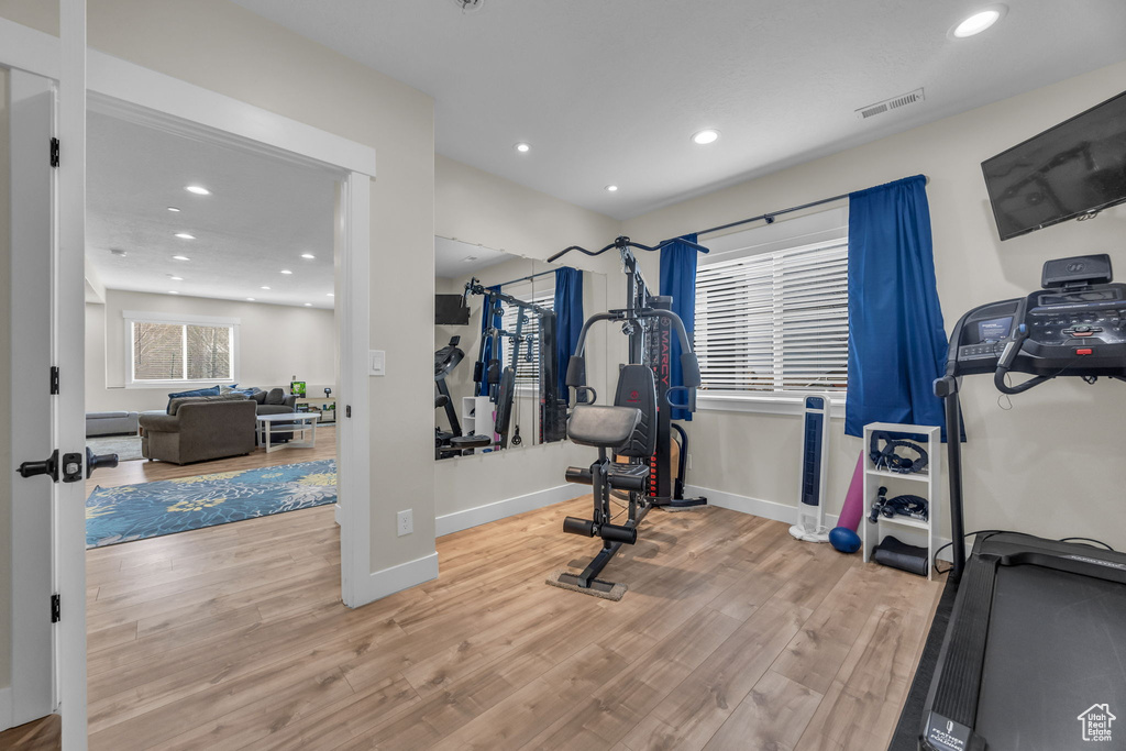 Workout area with recessed lighting, wood finished floors, visible vents, and baseboards