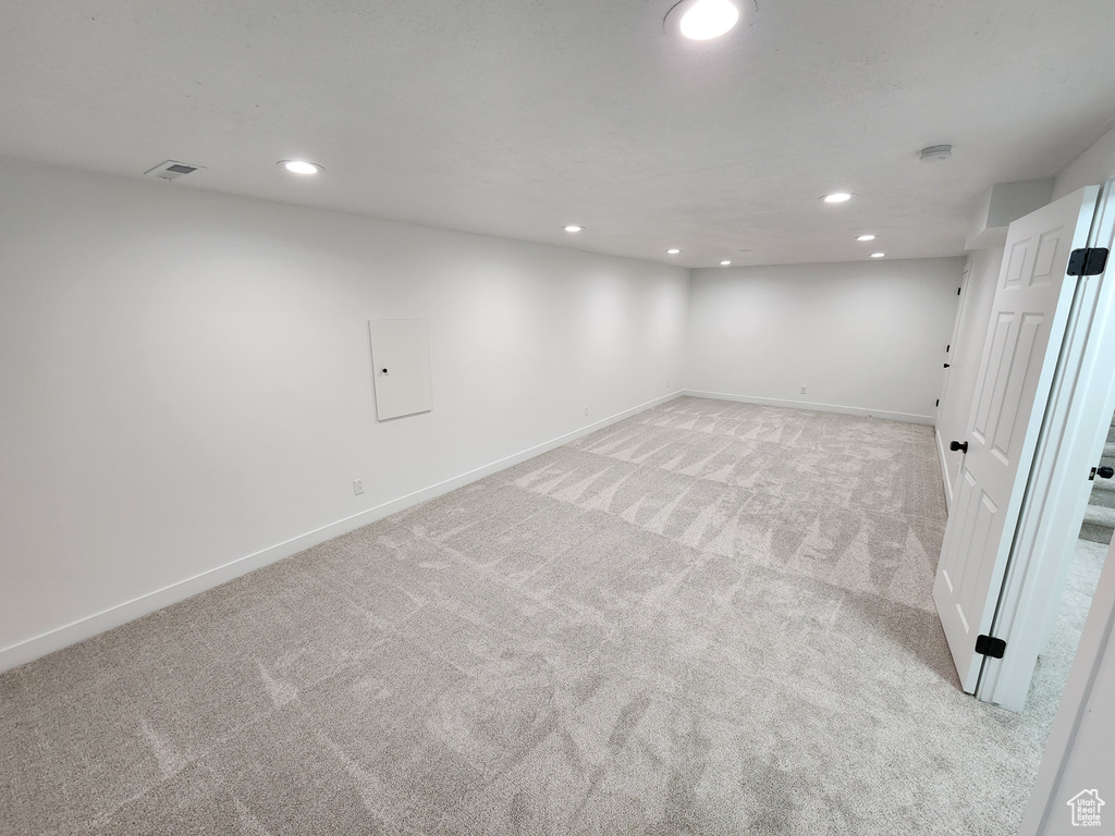 Finished basement featuring recessed lighting, light colored carpet, and baseboards