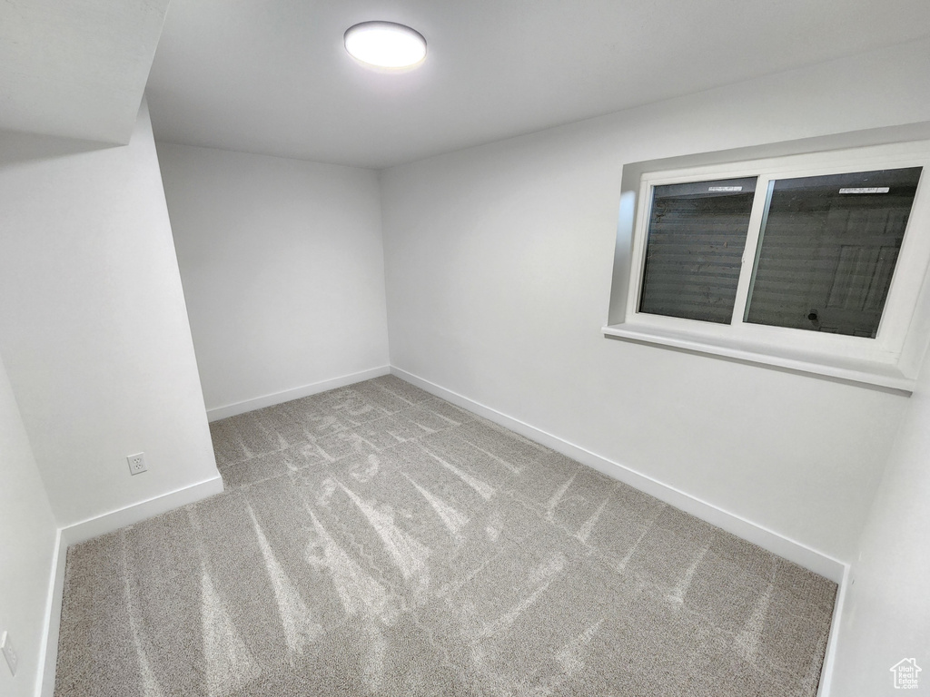 Carpeted spare room with baseboards