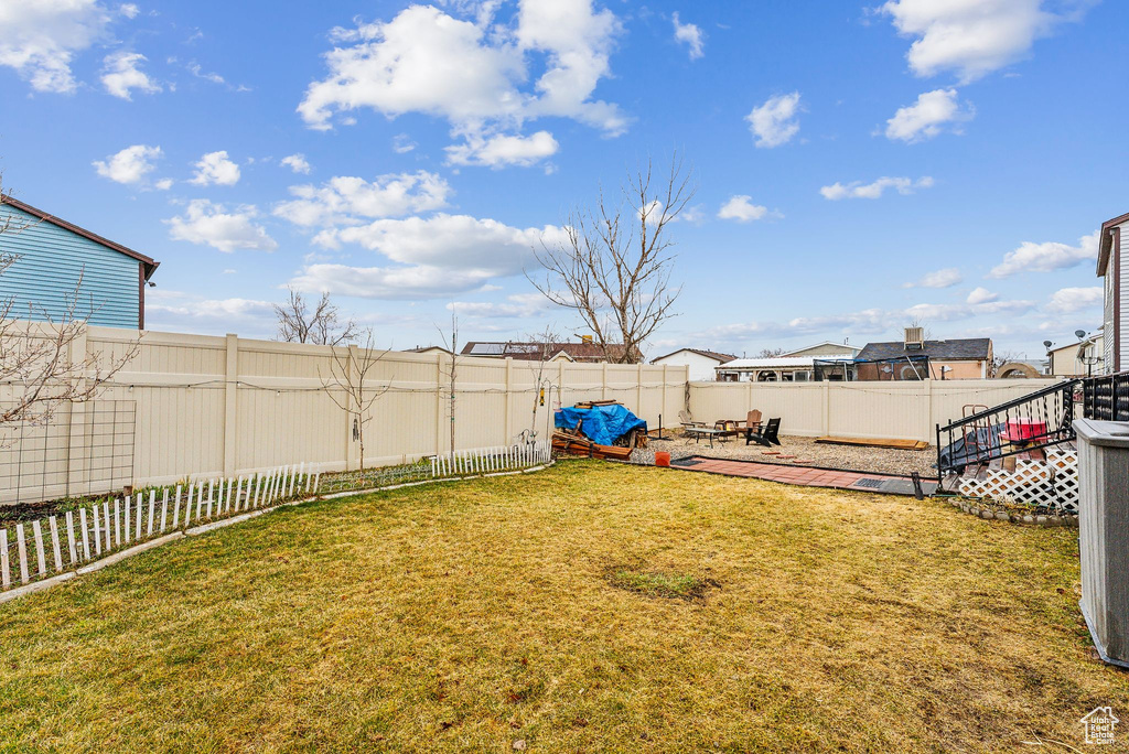 View of yard with a patio area and a fenced backyard