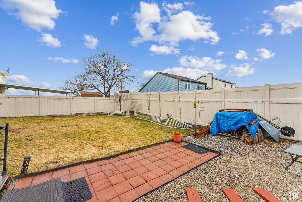 View of yard with a patio area and a fenced backyard