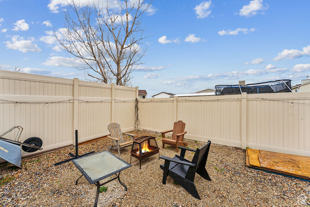 View of yard with a fenced backyard and an outdoor fire pit