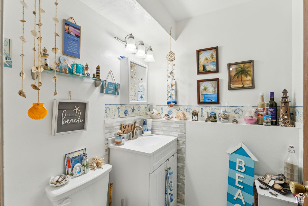 Half bathroom with vanity and toilet