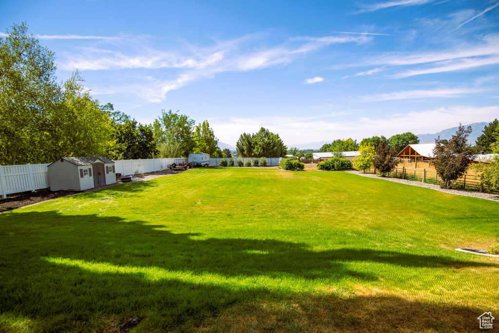 View of yard featuring an outbuilding, a shed, and a fenced backyard