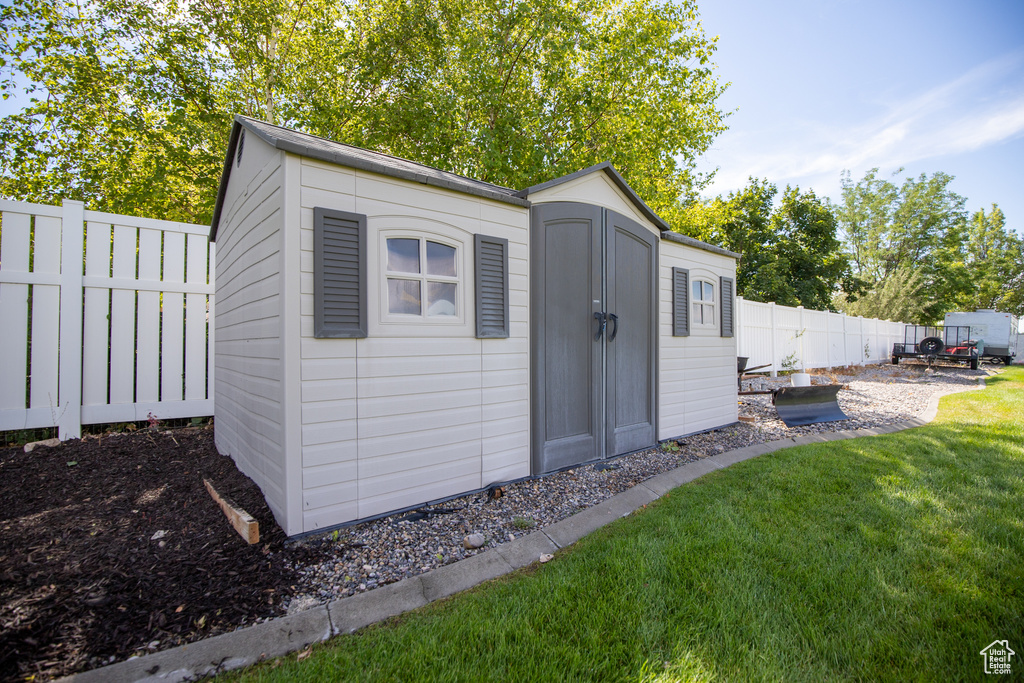 View of shed with a fenced backyard