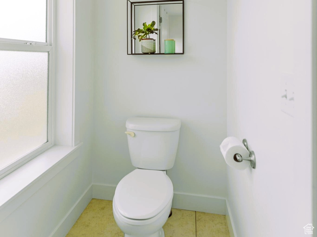 Bathroom featuring tile patterned flooring, toilet, baseboards, and visible vents