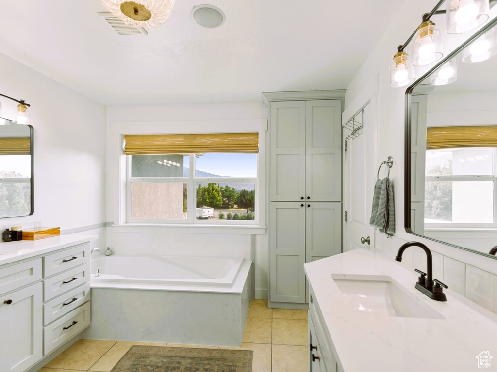 Full bathroom with tile patterned flooring, a healthy amount of sunlight, visible vents, and a sink