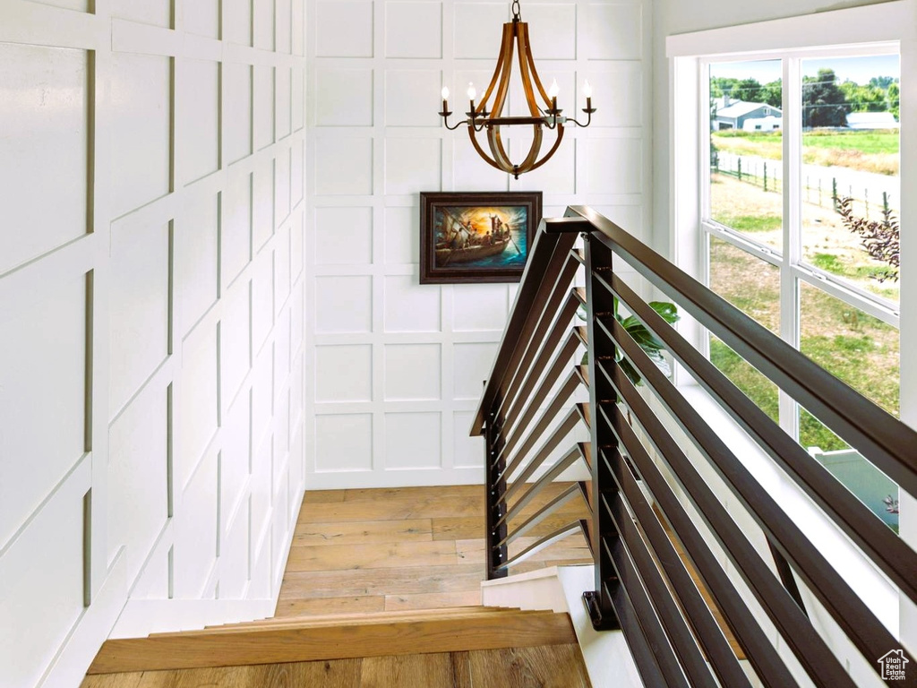 Interior space featuring a chandelier, an upstairs landing, and light wood finished floors
