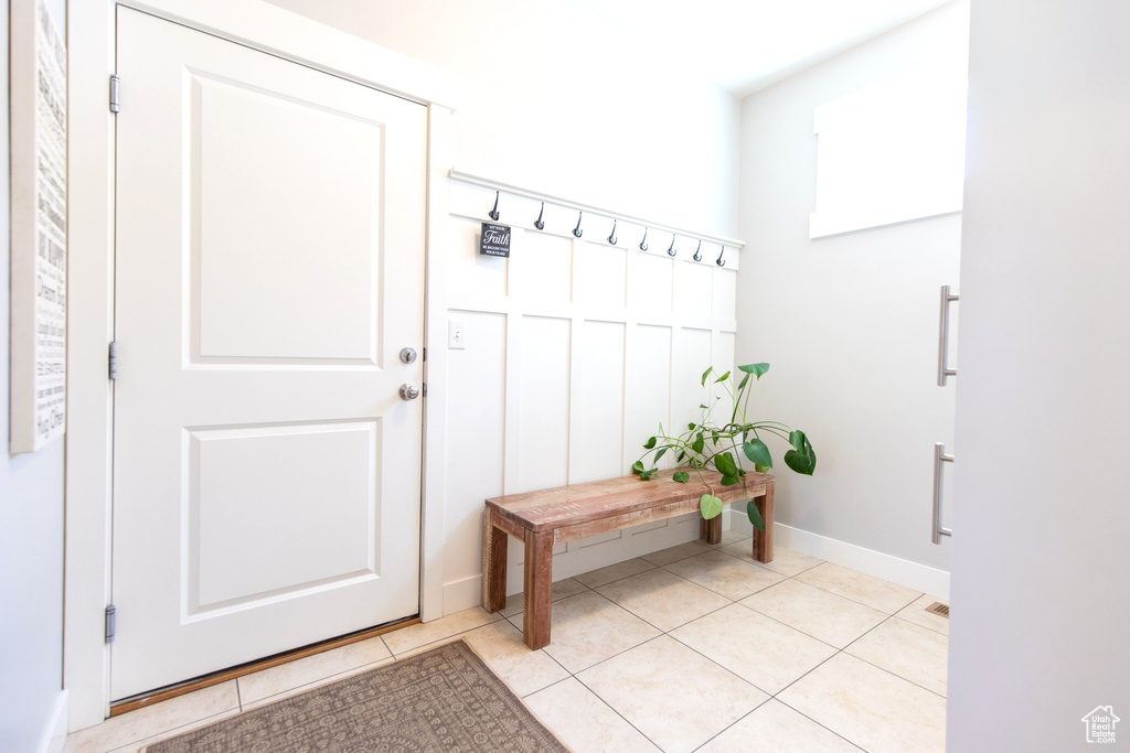 Mudroom featuring baseboards and light tile patterned flooring