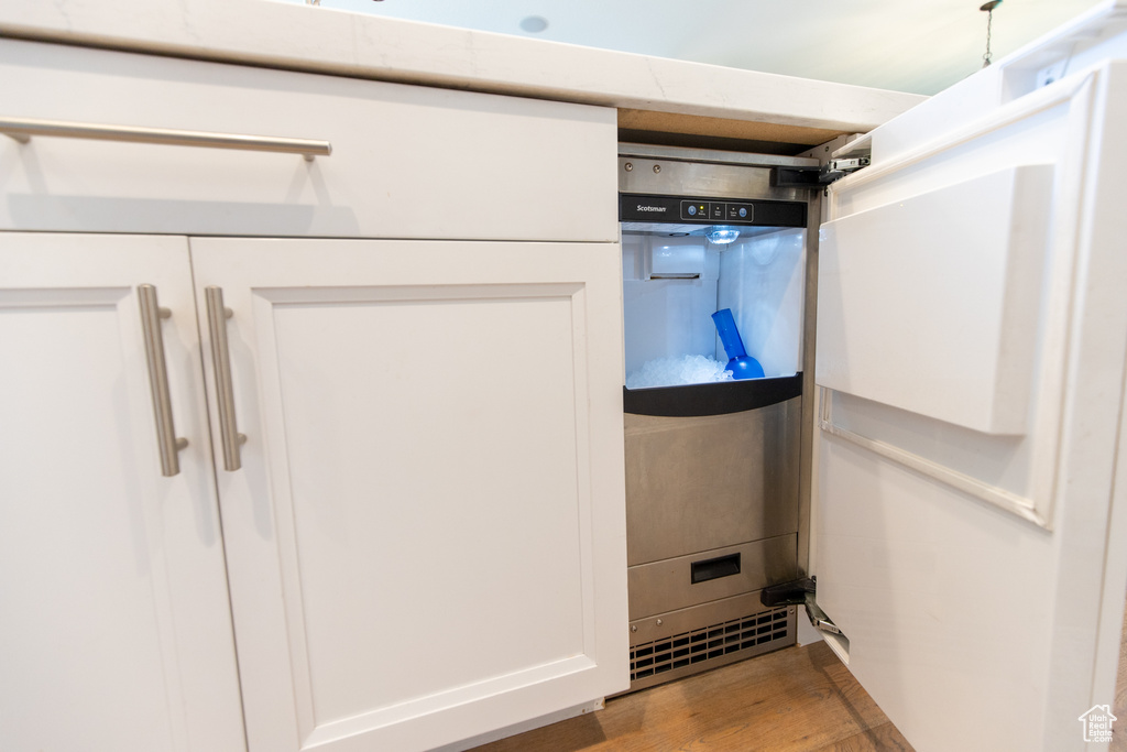 Room details with wood finished floors and white cabinetry