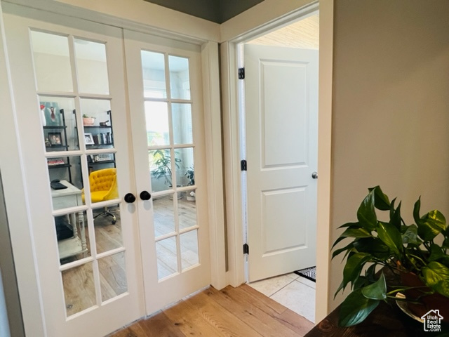 Doorway featuring french doors and light wood finished floors