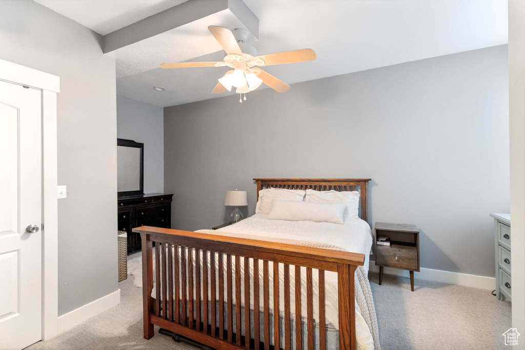 Bedroom with baseboards, light carpet, and a ceiling fan