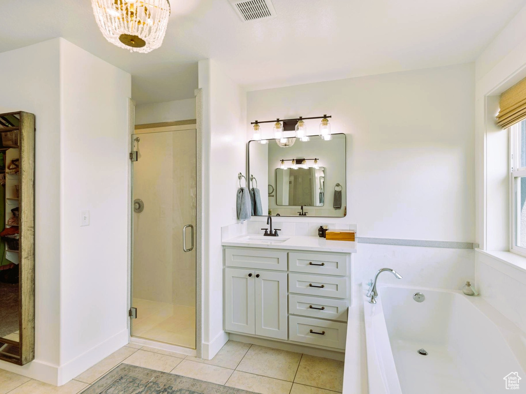 Full bath with tile patterned flooring, visible vents, a shower stall, a garden tub, and vanity