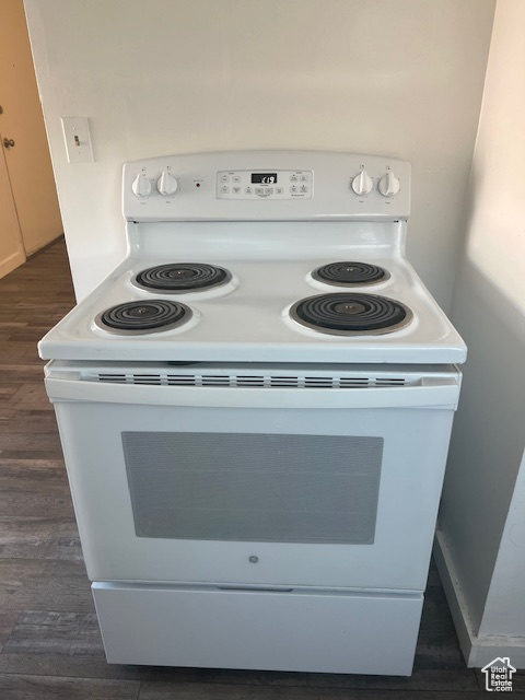 Interior details featuring dark wood finished floors and white electric stove