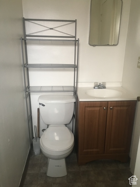 Bathroom with vanity, tile patterned floors, and toilet