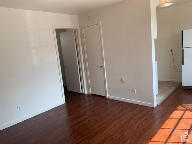 Empty room featuring baseboards and wood finished floors
