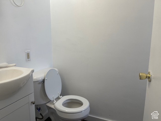 Half bathroom featuring toilet and vanity