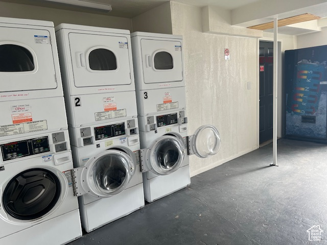 Community laundry room with washing machine and clothes dryer and stacked washer and dryer