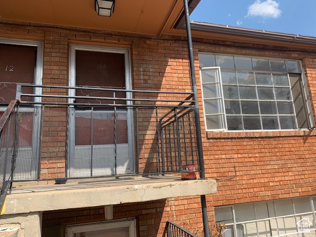 Entrance to property featuring brick siding