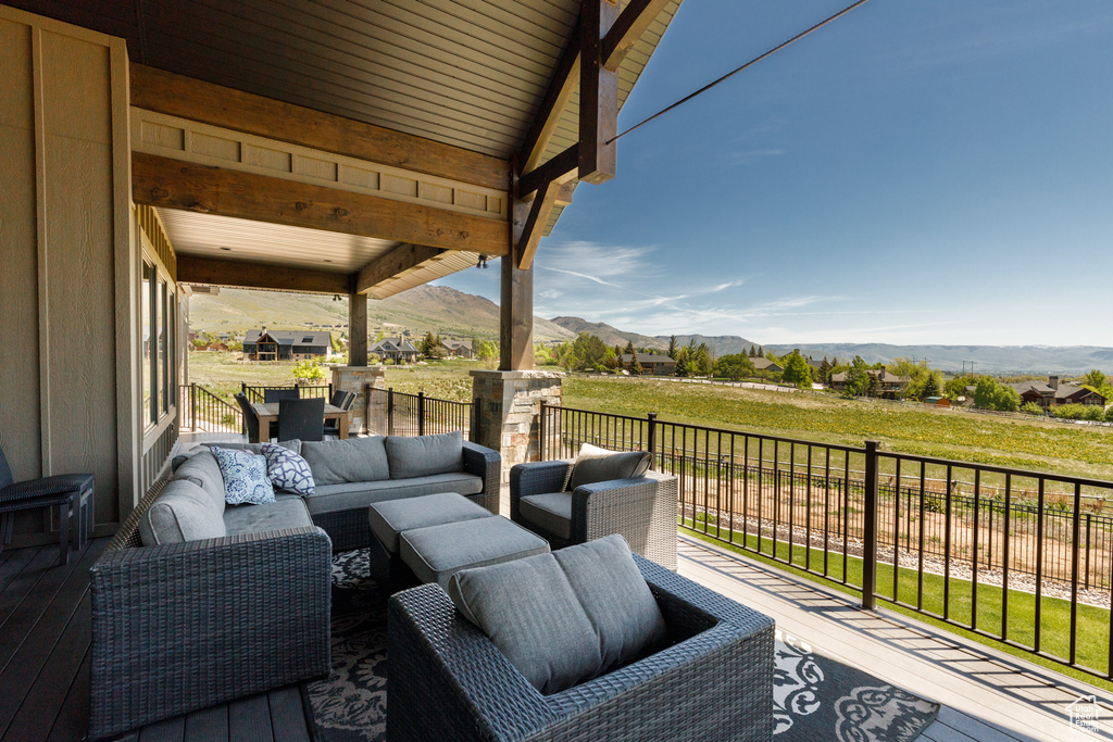 Deck featuring a mountain view and outdoor lounge area