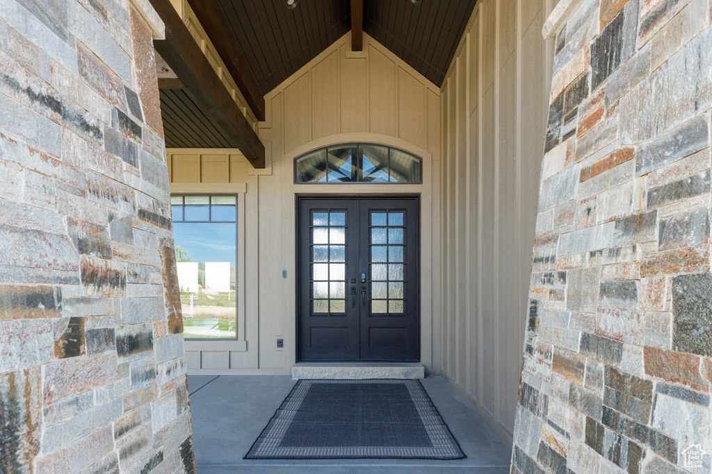 Doorway to property with french doors and board and batten siding