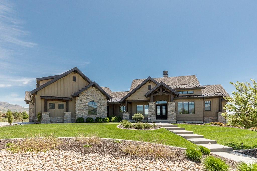 Craftsman-style house with board and batten siding and a front lawn