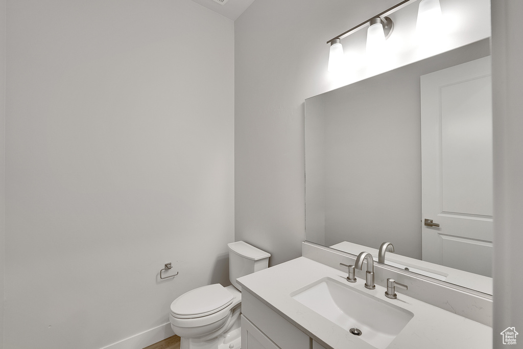 Half bathroom featuring toilet and vanity