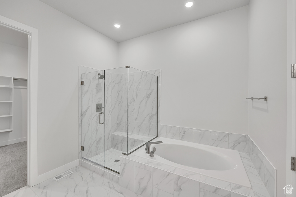 Full bath with a bath, a marble finish shower, a spacious closet, recessed lighting, and baseboards