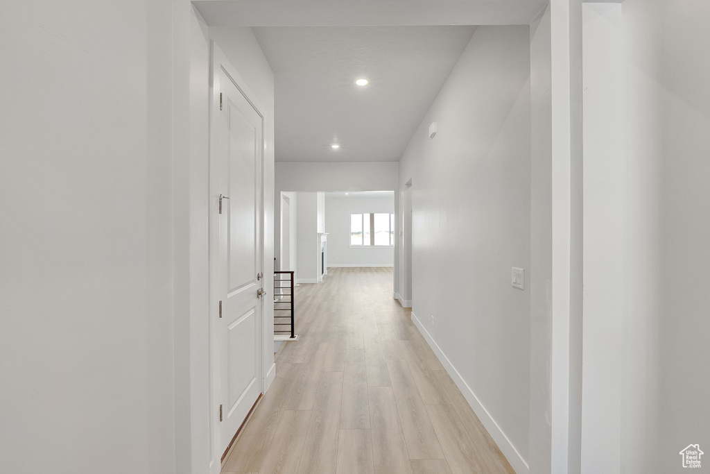 Hall featuring light wood-type flooring, recessed lighting, and baseboards