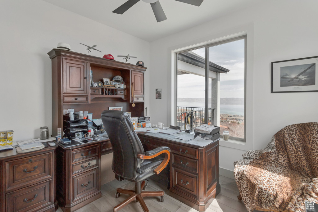 Home office featuring a ceiling fan and light wood-style flooring