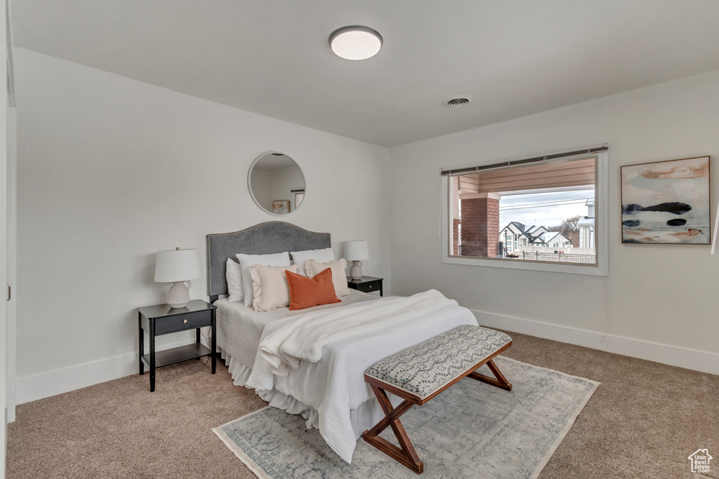 Bedroom featuring visible vents, baseboards, and carpet