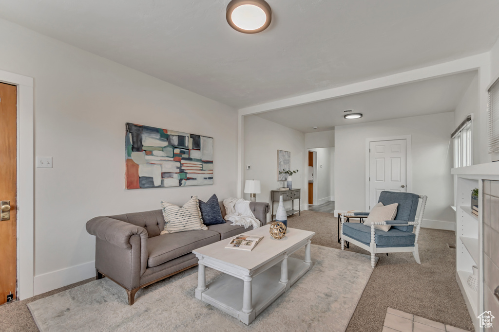 Living room with baseboards and light colored carpet