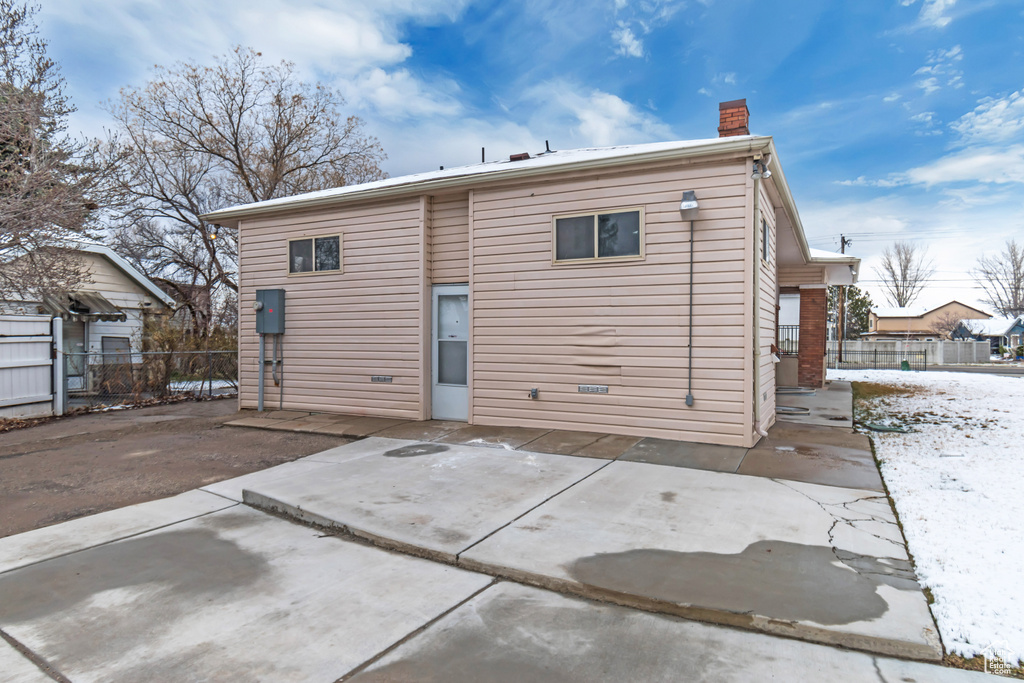 Back of property with a patio, fence, and a chimney