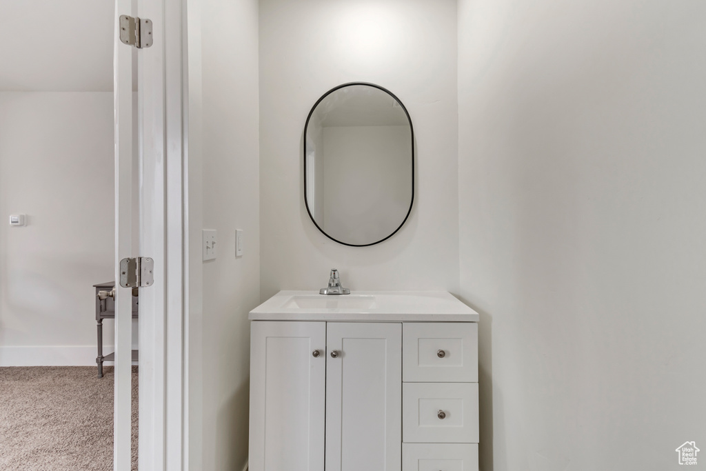 Bathroom featuring vanity and baseboards