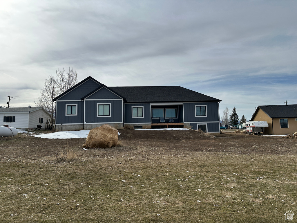 View of front of home featuring a shingled roof