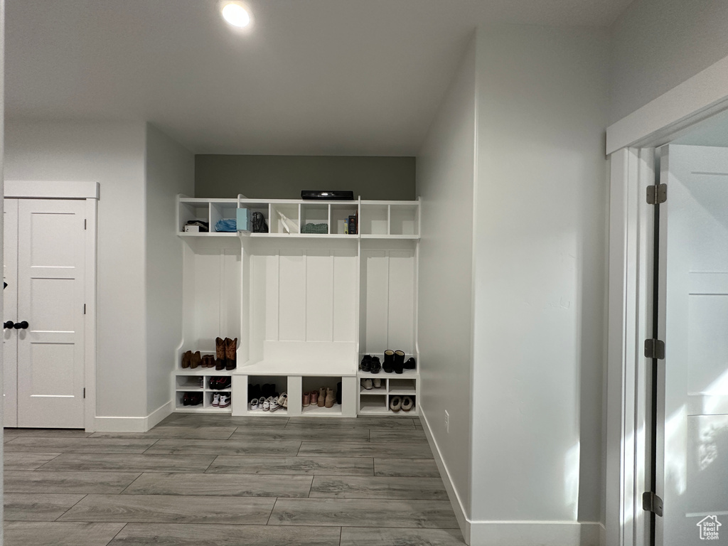 Mudroom with baseboards and wood tiled floor